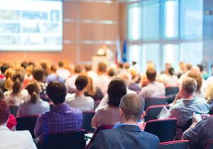 Audience seated at a conference presentation